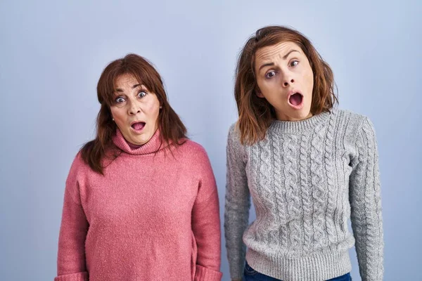 Mother Daughter Standing Blue Background Shock Face Looking Skeptical Sarcastic — Stock Photo, Image