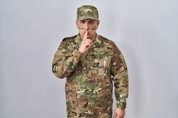 Hispanic Young Man Wearing Camouflage Army Uniform Asking Quiet Finger — Stock Photo, Image