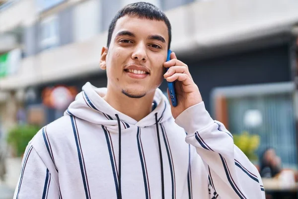 stock image Young man smiling confident talking on the smartphone at street