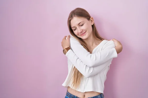 Joven Mujer Caucásica Pie Sobre Fondo Rosa Abrazándose Feliz Positivo —  Fotos de Stock