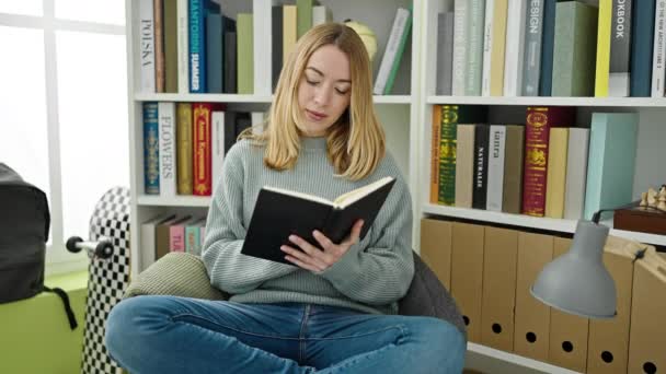 Young Blonde Woman Student Smiling Confident Reading Book Library University — Video