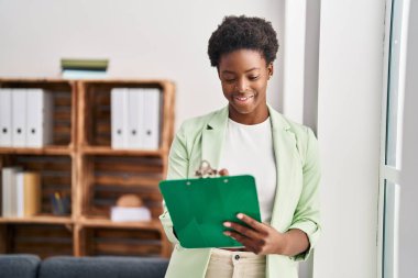African american woman psychologist holding clipboard at psychology center