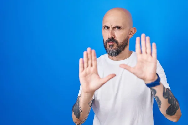 Een Spaanse Man Met Tatoeages Een Blauwe Achtergrond Die Handpalmen — Stockfoto