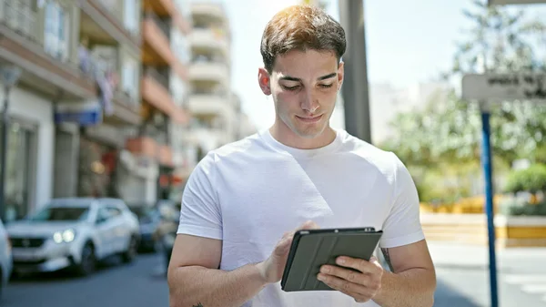 Young Hispanic Man Using Touchpad Street —  Fotos de Stock