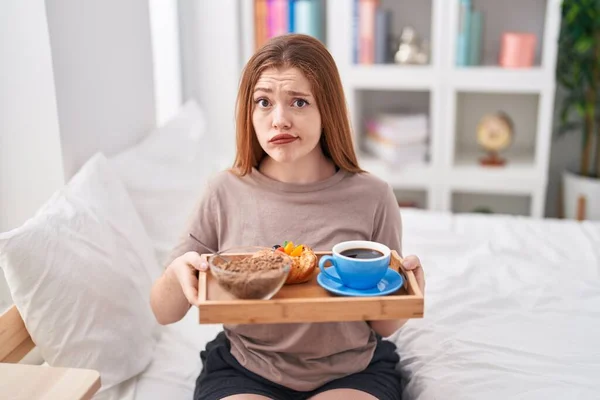 Redhead Woman Wearing Pajama Holding Breakfast Tray Skeptic Nervous Frowning — Fotografia de Stock