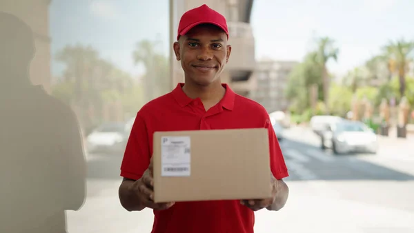 Young Latin Man Delivery Worker Holding Package Street — Stok fotoğraf