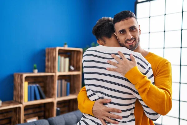 stock image Two man couple hugging each other standing at home