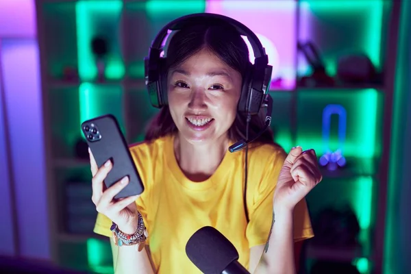 中国年轻女子玩电玩时 智能手机尖叫着自豪 高举双臂庆祝胜利和成功 — 图库照片