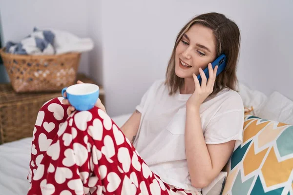 Young Woman Talking Smartphone Drinking Coffee Bedroom — Stockfoto