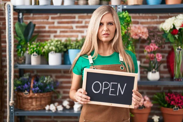 Young Woman Working Florist Holding Open Sign Skeptic Nervous Frowning — Stock Photo, Image