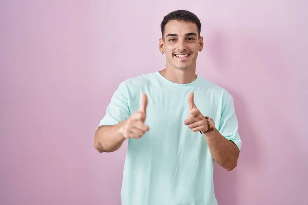Handsome Hispanic Man Standing Pink Background Pointing Fingers Camera Happy — Stock Photo, Image