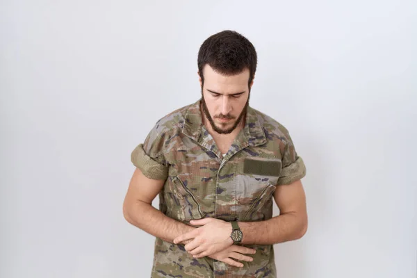 Young Hispanic Man Wearing Camouflage Army Uniform Hand Stomach Because — Stockfoto
