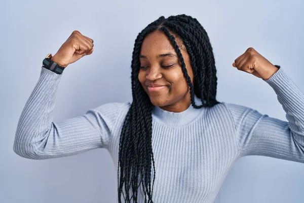 African American Woman Standing Blue Background Showing Arms Muscles Smiling — Stockfoto