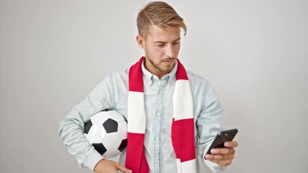 Young caucasian man supporting soccer team using smartphone over isolated white background