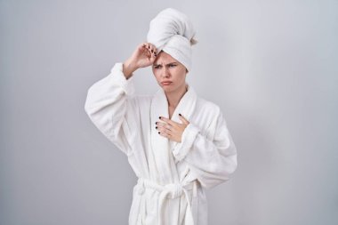 Kafkasyalı sarışın kadın hastalık, ateş, grip, soğuk algınlığı ve virüs yüzünden alnına bornoz giymiş. 