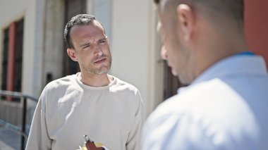 İki erkek doktor ve hasta hastanede tıbbi danışmanlık yapıyorlar.