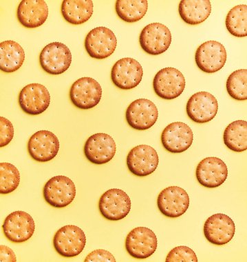  Delicious group of salty biscuits over isolated yellow background