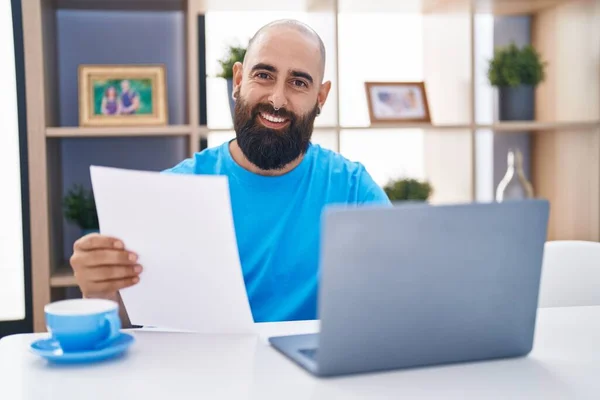 Young Bald Man Using Laptop Reading Paper Home —  Fotos de Stock