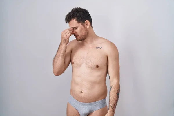 Young Hispanic Man Standing Shirtless Wearing Underware Tired Rubbing Nose — Stock Photo, Image