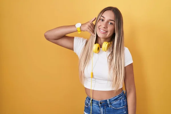 Mujer Rubia Joven Pie Sobre Fondo Amarillo Con Auriculares Sonriendo — Foto de Stock