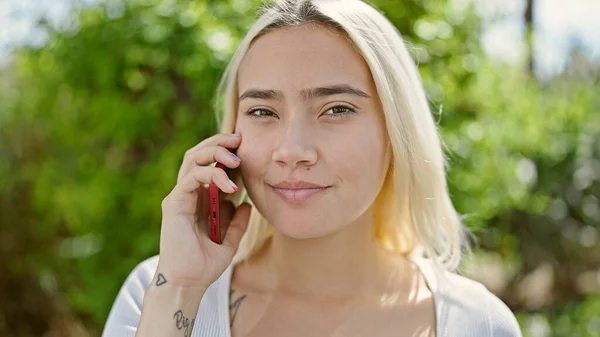 stock image Young beautiful hispanic woman smiling confident talking on the smartphone at park