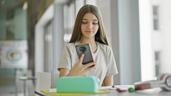 Kütüphanede Akıllı Telefon Kullanan Güzel Bir Kız Öğrenci — Stok fotoğraf