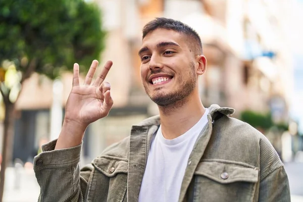 Jovem Hispânico Sorrindo Confiante Fazendo Sinal Rua — Fotografia de Stock