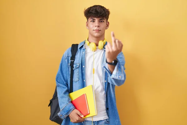 Hispanic Teenager Wearing Student Backpack Holding Books Showing Middle Finger — стоковое фото