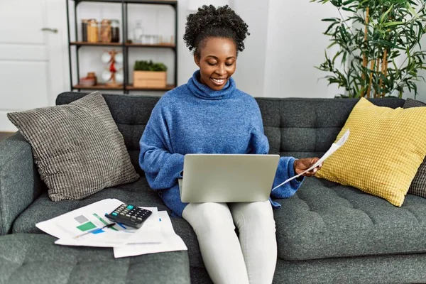 African American Woman Reading Document Using Laptop Accounting Home — Stockfoto