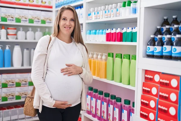 Young Pregnant Woman Customer Smiling Confident Touching Belly Pharmacy — Stock fotografie