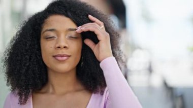 African american woman smiling confident looking to the side at street