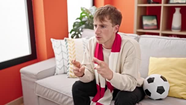 Young Caucasian Man Supporting Soccer Team Crossing Fingers Luck Home — Stock Video