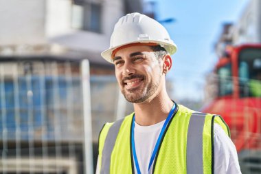 Young hispanic man architect smiling confident standing at street