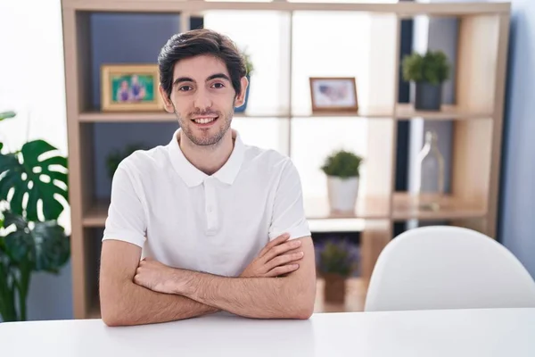 Young Hispanic Man Smiling Confident Sitting Table Arms Crossed Gesture — 图库照片