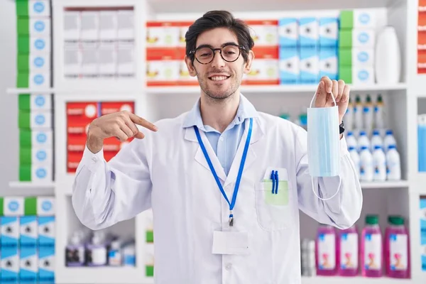 Fiatal Spanyol Férfi Aki Gyógyszertárban Dolgozik Biztonsági Maszkot Tart Ujjal — Stock Fotó