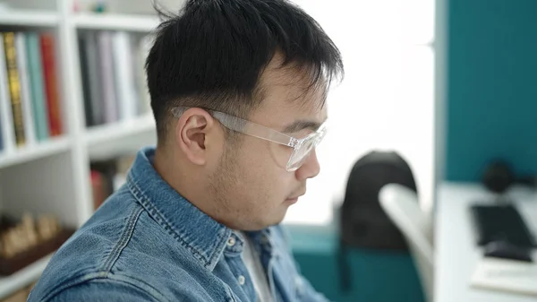 Молодой Китайский Студент Сидит Столом Расслабленным Выражением Лица Библиотечном Университете — стоковое фото