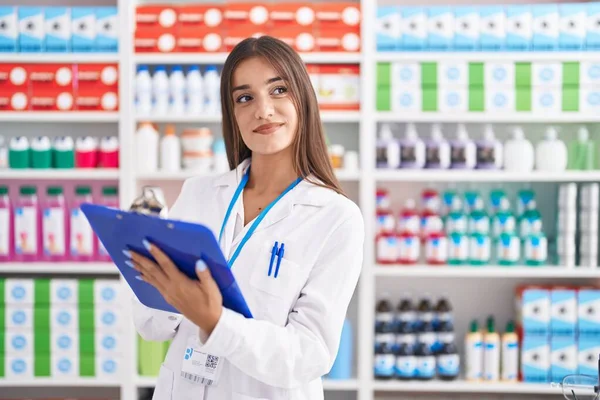 Young Beautiful Hispanic Woman Pharmacist Smiling Confident Writing Document Pharmacy — Photo