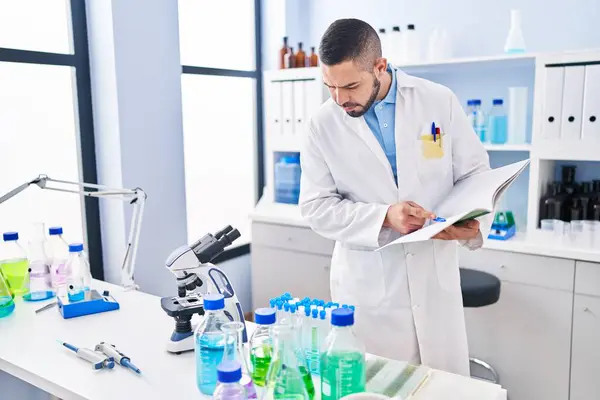 Young Latin Man Scientist Writing Notebook Laboratory — Stock Photo, Image
