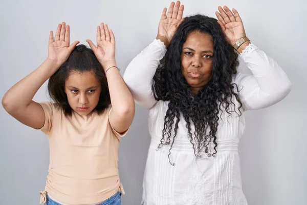 母親と若い娘が白い背景の上に立ち 手の手のひらで皮肉と懐疑的なジェスチャーをしています イースターウサギのコンセプト — ストック写真