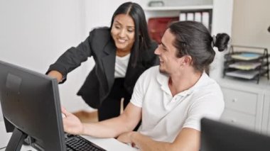Man and woman business workers shake hands working at office