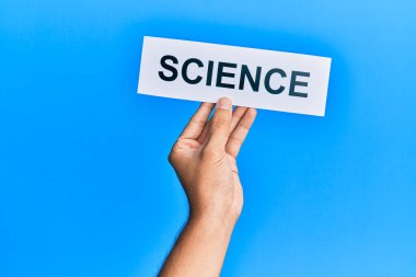 Hand of caucasian man holding paper with science word over isolated blue background