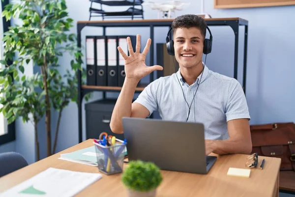 Young Hispanic Man Working Office Wearing Headphones Showing Pointing Fingers — Stock Photo, Image