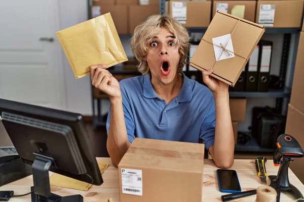 Young Man Working Small Business Ecommerce Holding Packages Afraid Shocked — Photo