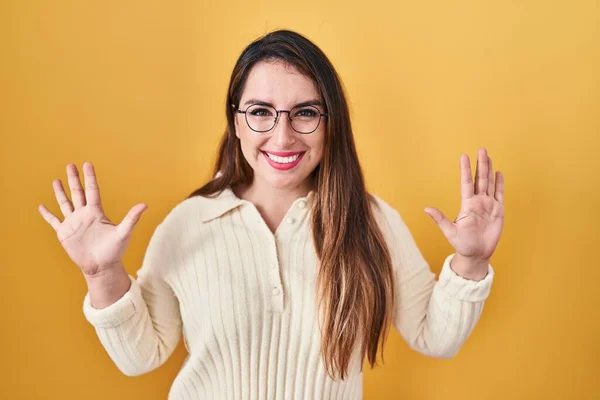 Jonge Latino Vrouw Staande Gele Achtergrond Tonen Wijzen Met Vingers — Stockfoto