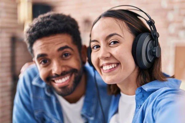 stock image Man and woman musicians listening to music make selfie by camera at music studio