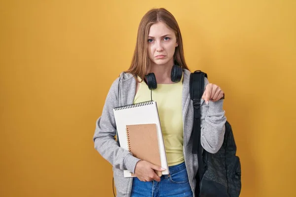 Young Caucasian Woman Wearing Student Backpack Holding Books Pointing Looking — Stock Photo, Image