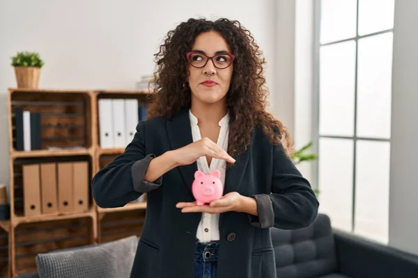 Young Hispanic Woman Holding Piggy Bank Smiling Looking Side Staring — Stock Photo, Image