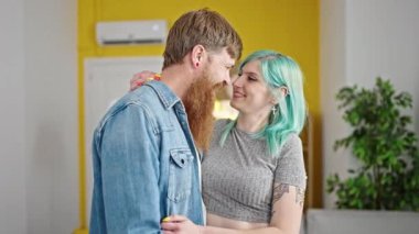 Man and woman couple smiling confident hugging each other at home