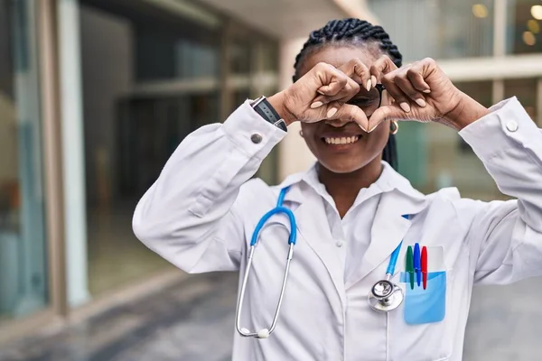 African American Woman Doctor Smiling Confident Doing Heart Gesture Hands — Photo