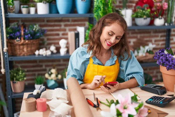 Joven Hermosa Florista Hispana Sonriendo Confiada Usando Teléfono Inteligente Floristería —  Fotos de Stock